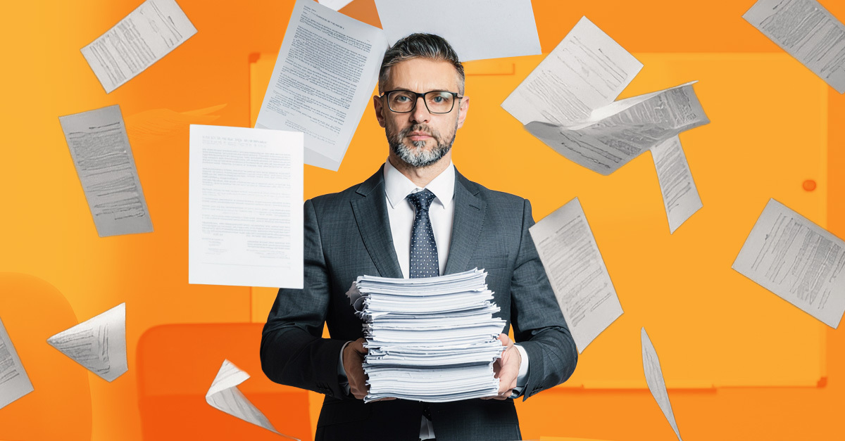 Business professional overwhelmed by stacks of paper documents representing the need for OCR scanning and document digitization solutions.